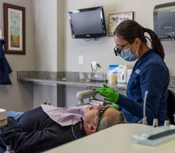 Dental team member treating a patient
