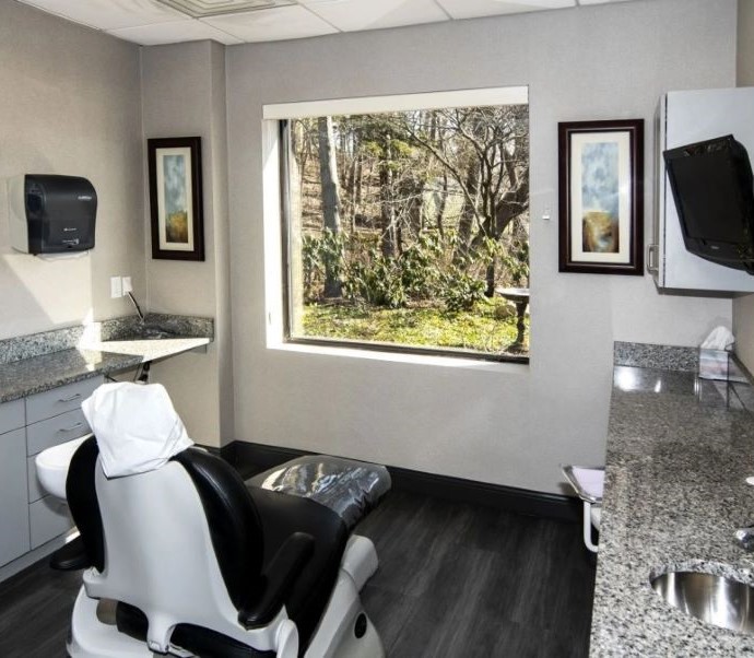 Dental treatment room with trees visible through window