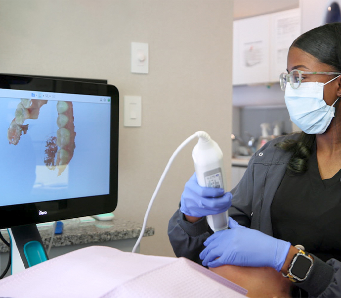 Dentist taking digital impressions of a patients teeth