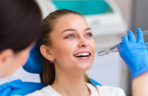 Woman smiling about to have tooth extracted