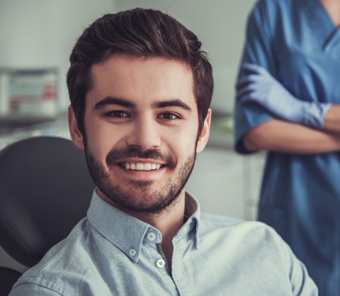 Smiling young man sitting in dental chair