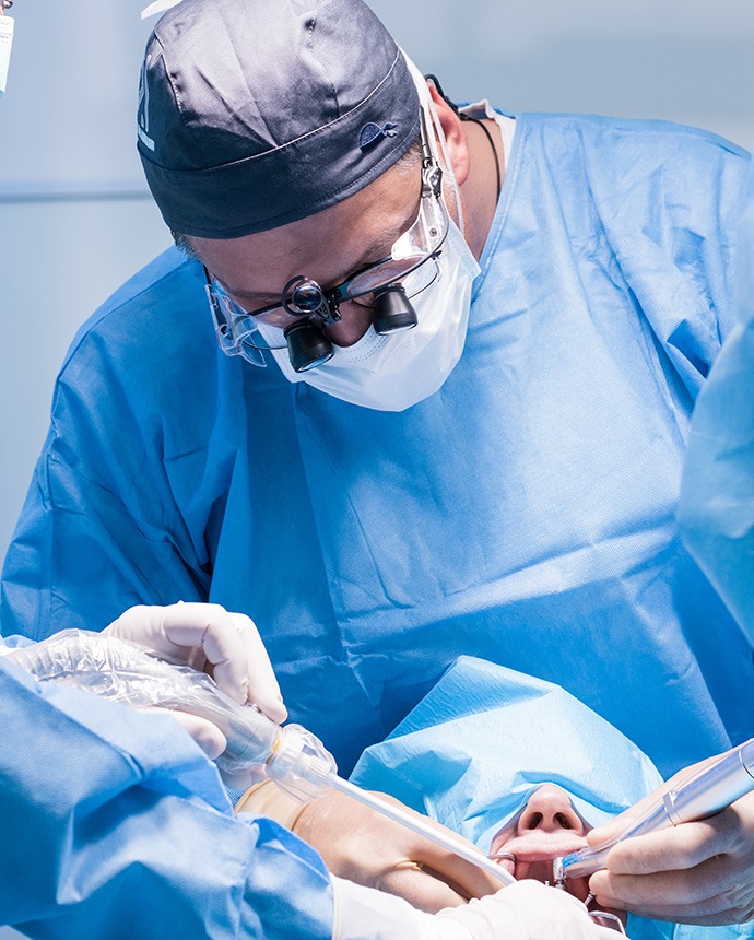 Dental team surgically placing implants