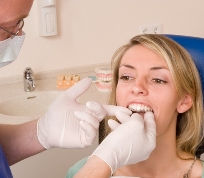 Hand holding an Invisalign clear aligner in Braintree