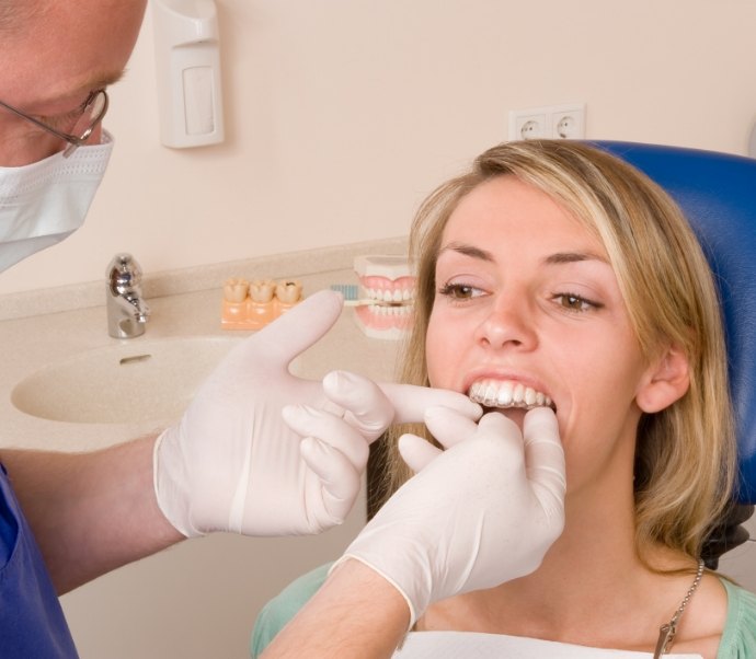 Dentist fitting a patient with an Invisalign tray