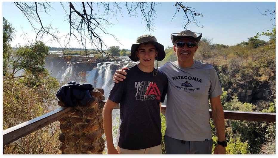 Doctor Salem with his son with a waterfall in background