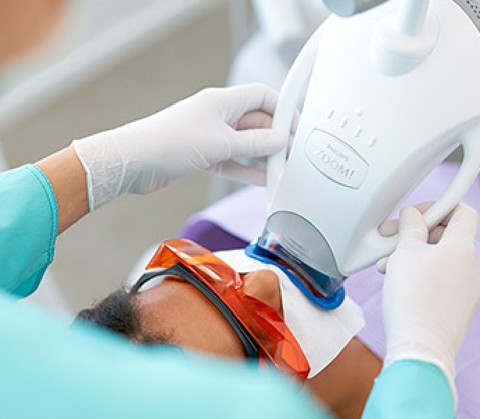 Dental patient receiving professional teeth whitening in Braintree dental office