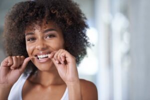 Young woman flossing. 
