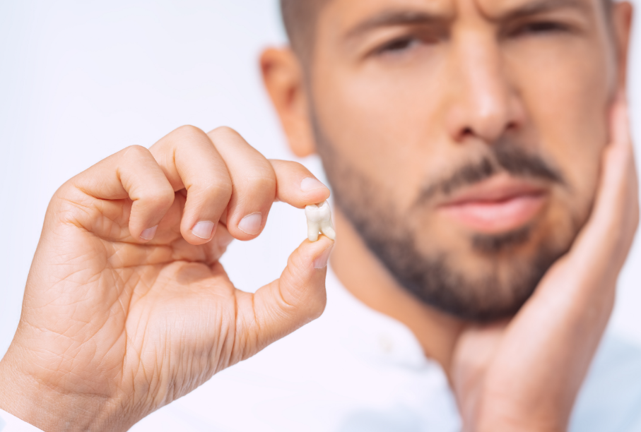 Man holding tooth
